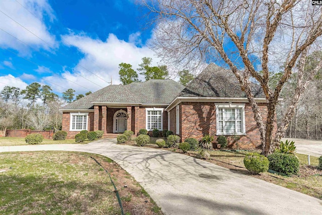 ranch-style home featuring a front yard