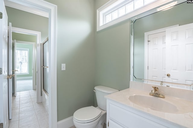 full bathroom with toilet, oversized vanity, a wealth of natural light, and tile floors