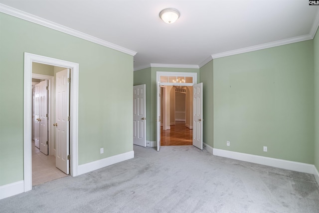 unfurnished bedroom with light carpet and crown molding