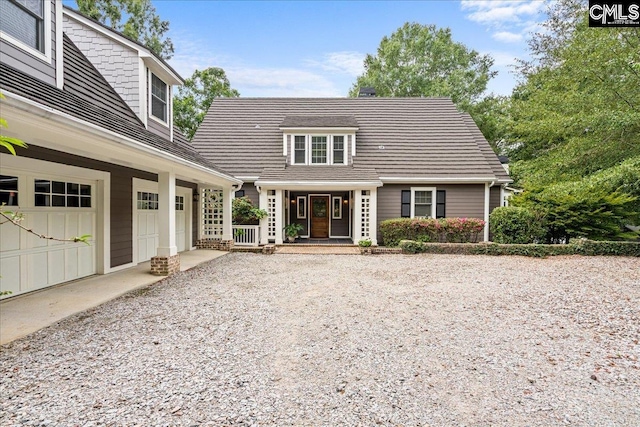 view of front facade featuring covered porch and a garage