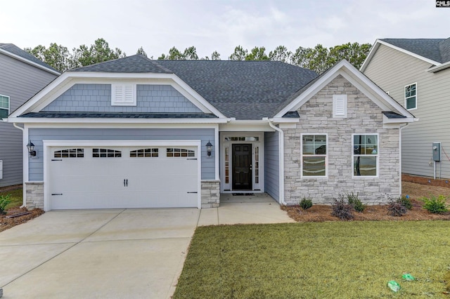 craftsman house with a shingled roof, a front lawn, a garage, stone siding, and driveway