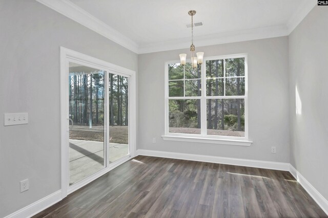 unfurnished dining area featuring baseboards, visible vents, dark wood-style flooring, and ornamental molding