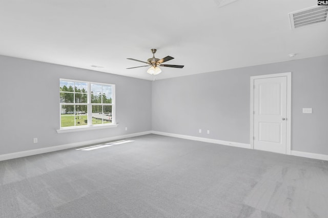 empty room featuring a ceiling fan, baseboards, visible vents, and carpet floors