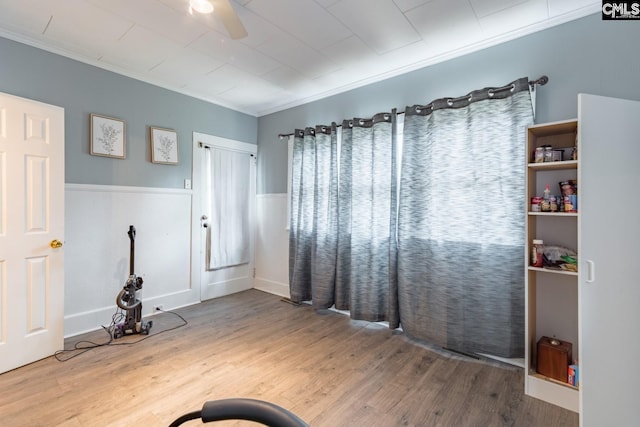 interior space with crown molding, ceiling fan, and hardwood / wood-style flooring