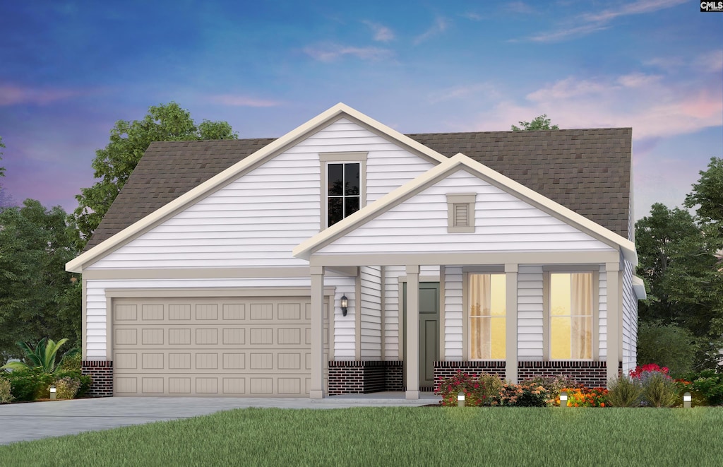 view of front of home featuring a yard and a garage