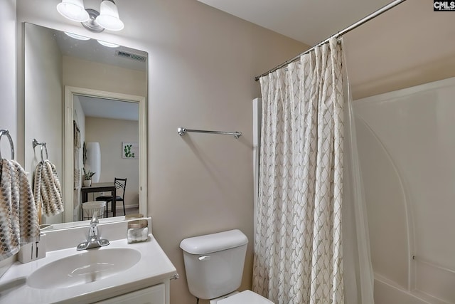 bathroom featuring oversized vanity and toilet