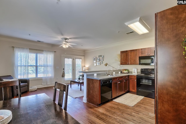 kitchen with ceiling fan, black appliances, sink, crown molding, and hardwood / wood-style flooring