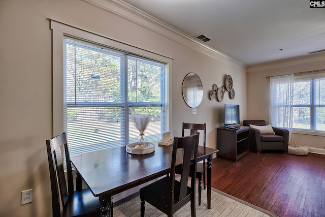 dining room featuring crown molding and dark hardwood / wood-style floors