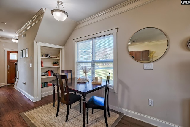 dining room with built in shelves, ornamental molding, and dark hardwood / wood-style flooring