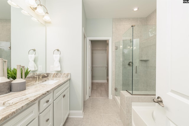 bathroom featuring vanity, tile patterned floors, and separate shower and tub