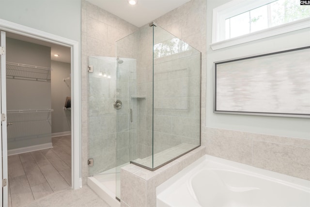 bathroom featuring shower with separate bathtub