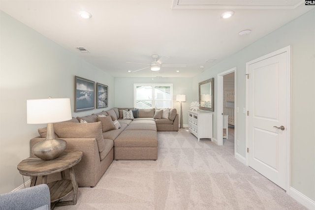 carpeted living room with ceiling fan