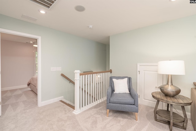 sitting room featuring light colored carpet