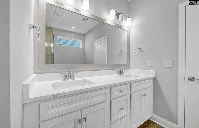 bathroom featuring vanity and hardwood / wood-style floors