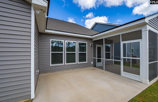 view of patio with a sunroom