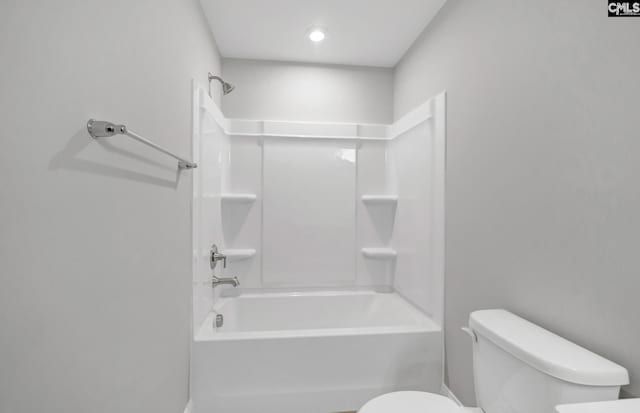 bathroom featuring bathtub / shower combination and toilet