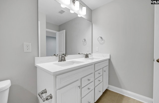 bathroom with vanity, toilet, and tile patterned flooring