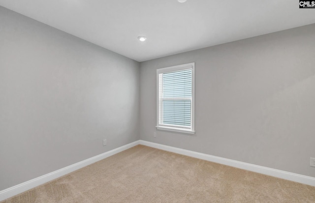 unfurnished room with light carpet