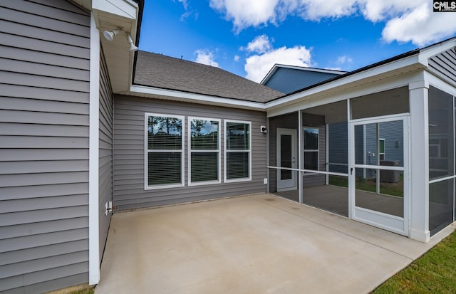 view of patio featuring a sunroom