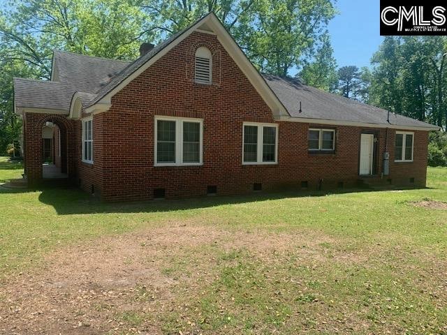 rear view of property with a yard