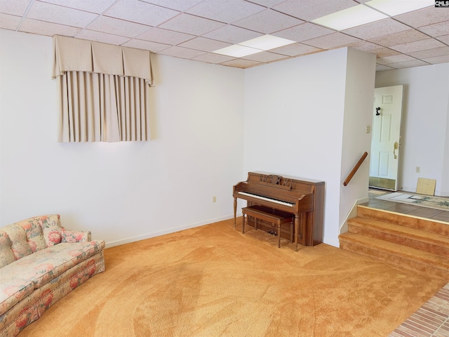 unfurnished room featuring a paneled ceiling and carpet