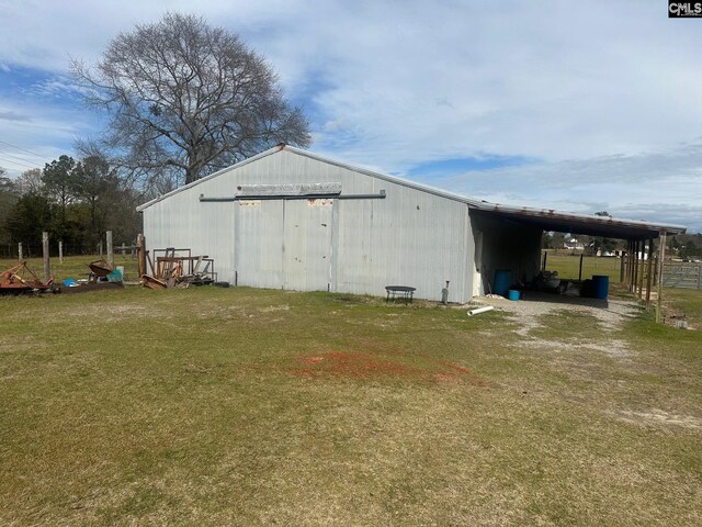 view of outbuilding featuring a yard