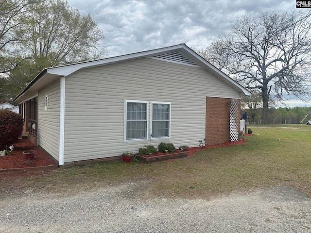 view of property exterior with a yard