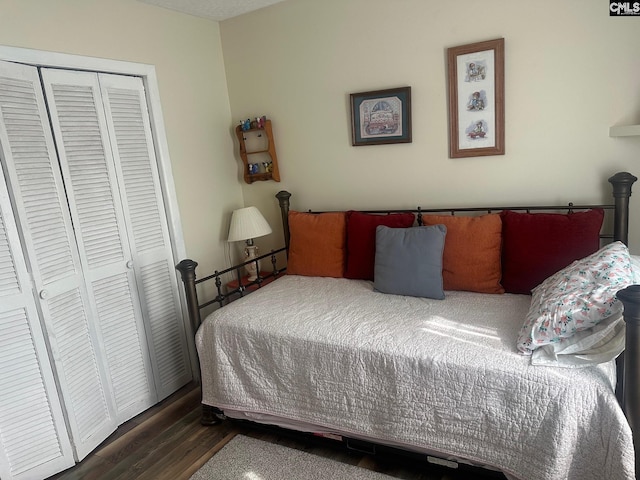 bedroom featuring a closet and dark hardwood / wood-style floors
