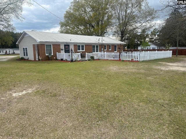 rear view of house featuring a yard