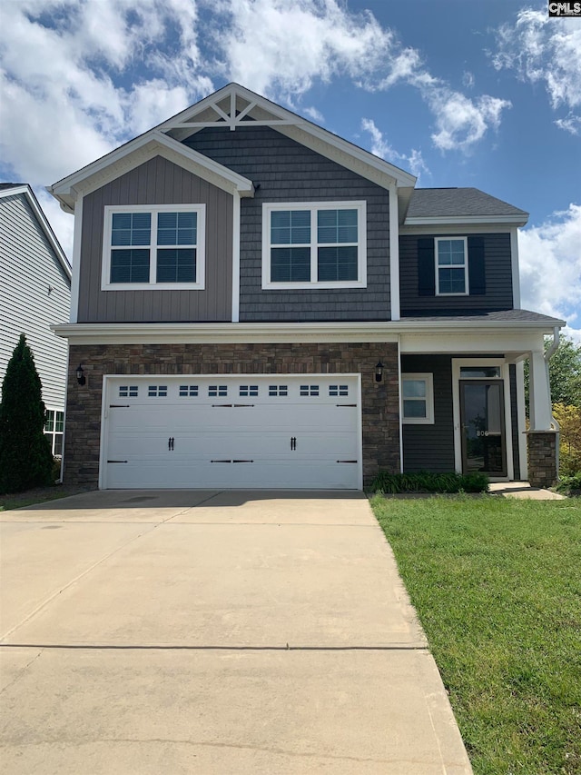 view of front facade with a garage and a front lawn