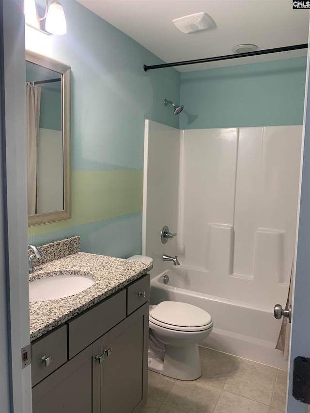 full bathroom with tile patterned flooring, vanity, toilet, and washtub / shower combination