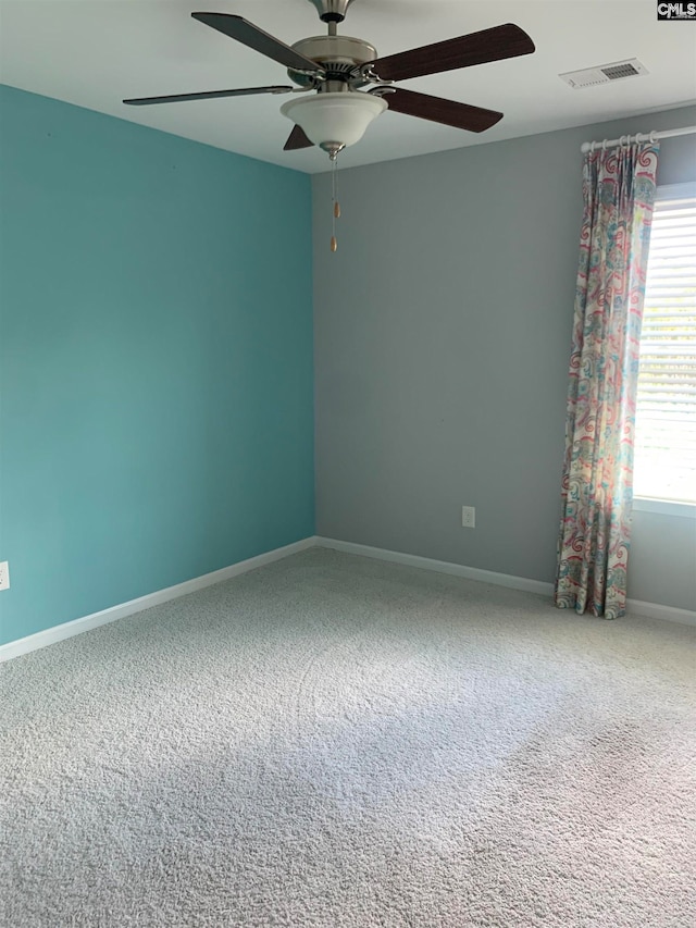 empty room featuring ceiling fan and carpet floors