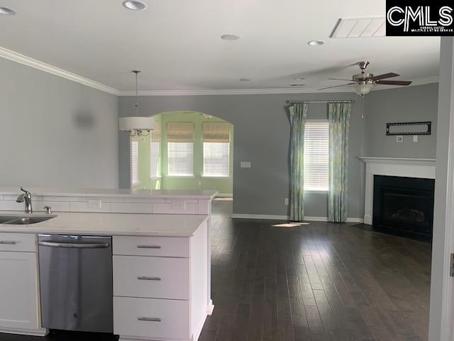 kitchen featuring ceiling fan, sink, decorative light fixtures, dishwasher, and white cabinetry