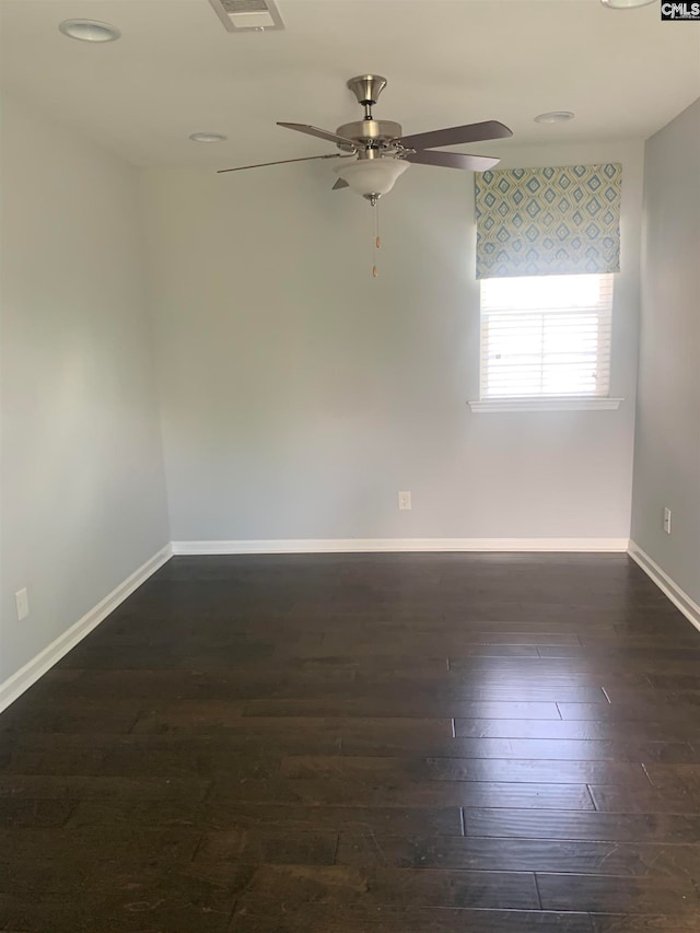 empty room featuring ceiling fan and dark hardwood / wood-style flooring