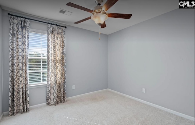 carpeted empty room with plenty of natural light and ceiling fan