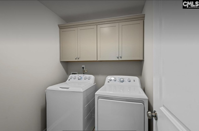 washroom featuring cabinets and independent washer and dryer