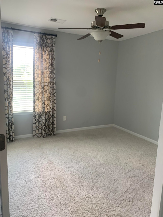 empty room featuring ceiling fan and carpet floors