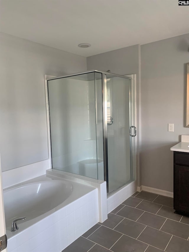 bathroom featuring tile patterned floors, vanity, and plus walk in shower