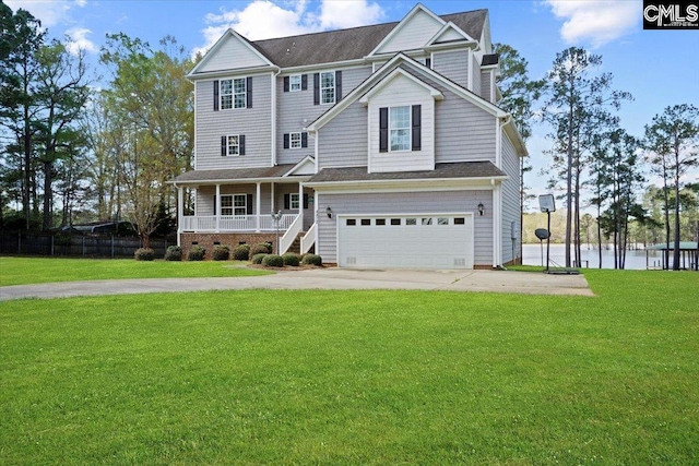 view of front of property with a front lawn, covered porch, and a garage