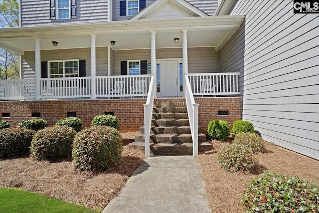 view of exterior entry with a porch