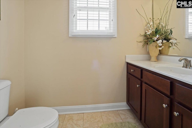 bathroom featuring toilet, tile flooring, and vanity