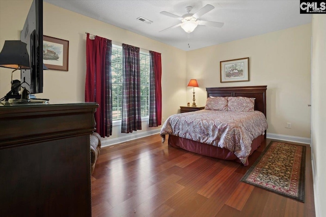 bedroom featuring ceiling fan and dark hardwood / wood-style floors