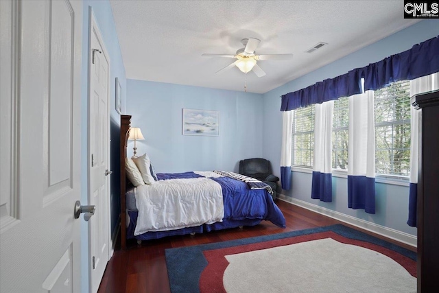 bedroom featuring ceiling fan and dark hardwood / wood-style floors