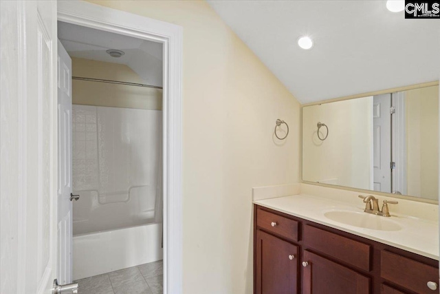 bathroom with shower / washtub combination, tile floors, and vanity with extensive cabinet space