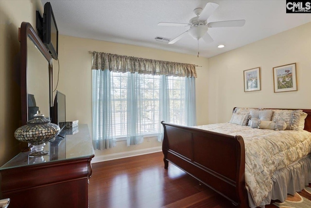 bedroom with ceiling fan and dark wood-type flooring