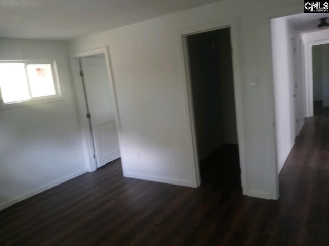 spare room featuring dark wood-type flooring