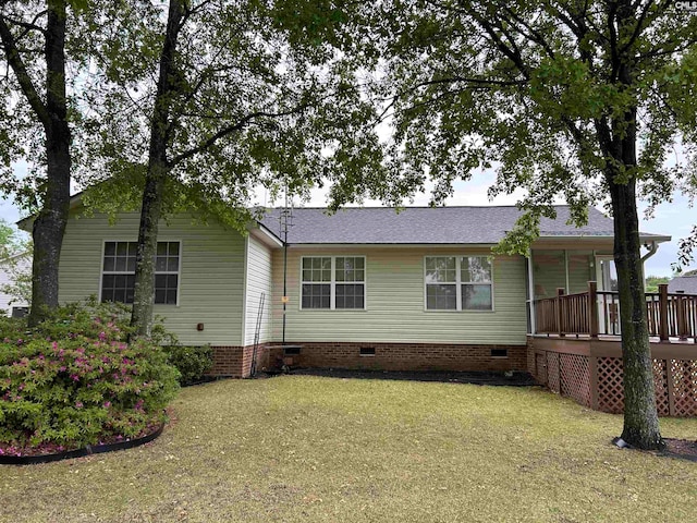 view of front of property with a front yard and a wooden deck