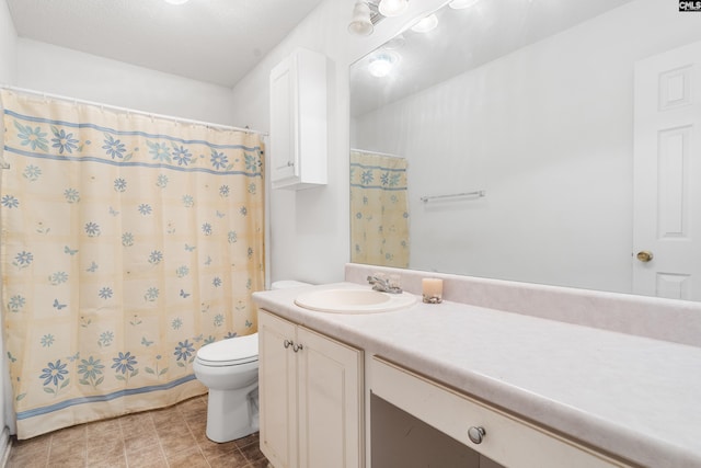 bathroom featuring toilet, tile flooring, and vanity