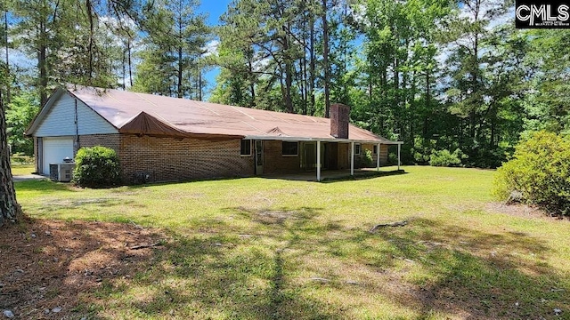 exterior space with central AC and a garage