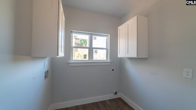 washroom with hookup for a washing machine, cabinets, dark hardwood / wood-style floors, and hookup for an electric dryer